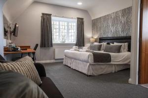 hotel room with king size bed and accents in grey