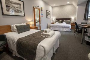 room with two double beds with accents in white and grey