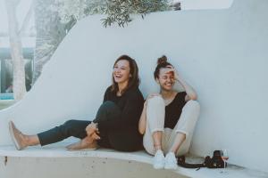 Two women sat together laughing