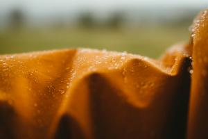 Rain falling on a yellow waterproof coat 