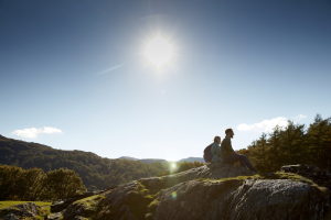 Eryri with two walkers sitting on a rock