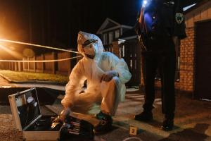 Man in hazmat suit on street at night