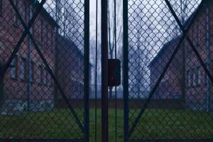 Fenced gate with buildings behind