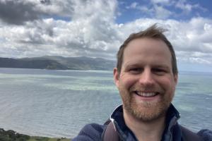 Benjamin Jarrett on the Great Orme with the view of Conwy behind him