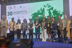 Photo of symposium attendees on stage