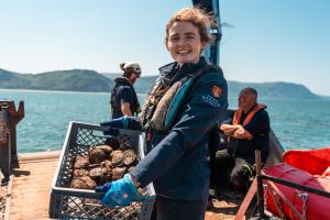 Project staff holding oysters 