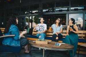 Image of 4 people socialising outside a cafe
