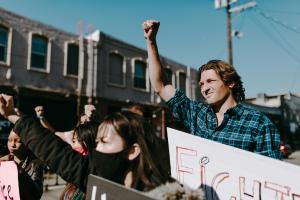 Image of individuals protesting in the open air