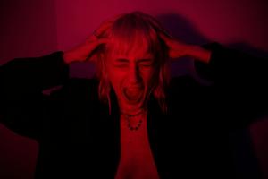 Image of an individual in a state of panic with a red light glow