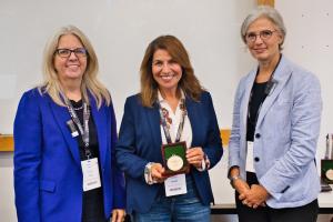 Professor Katy Mason, President of BAM (on the right), and Professor Emma Parry Chair of BAM (on the left), presenting the award to Dr Fariba Darabi