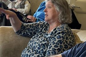 Picture of Beryl sitting on a sofa participating in a conversation