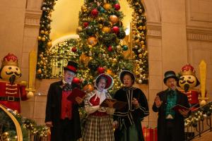 Image of Victorian people in front of a large christmas tree