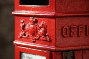 Image of section of red post box with the letters POST in capital