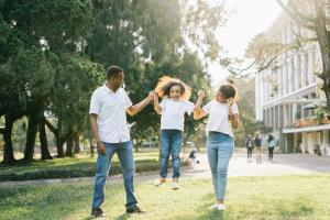 Happy Family of Three Walking Together