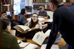 A group of studenst in the archives reading room