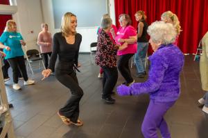 Professional Dancer Amy Dowden, Dance to Health Teacher Emma Jenkins and class participants.