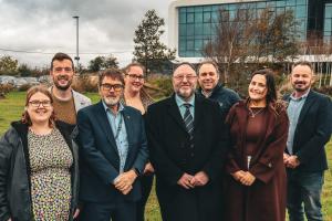 Group of people standing in front of Bangor University's Science Park 