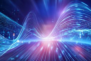 Abstract illustration of future-generation communications showing glowing fibre-optic light streams merging with wireless signal waves and geometric network patterns, generated using JCRoberts and Adobe Firefly.