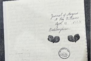 Photograph of a document in an archive with handwriting in black ink