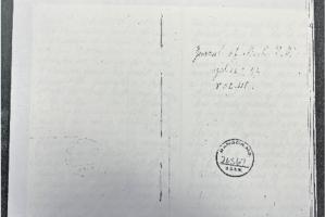 Photograph of a document in an archive with handwriting in black ink