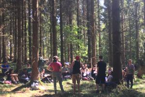 a group of students standing in a forest