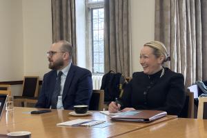 Two Welsh Government ministers sitting by a table 