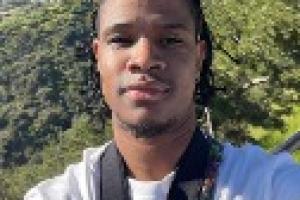 Image of Kamron Roberts with trees and blue sky in the background