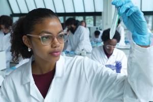 Medical student examining a sample in a test tube