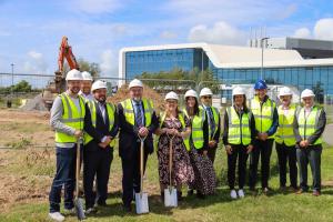 A group photo of people in high-viz to mark work officially beginning on the second building at Bangor University’s Science Park, M-SParc