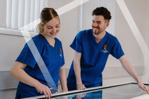 Two medical students working on a digital anatomy table
