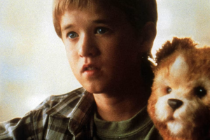 A child with a synthetic robot that looks like a teddy bear