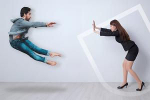 A woman pushing a man away from a distance using superpowers