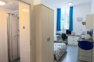 St Mary's Studio with a bed, desk, chair, shower and kitchenette