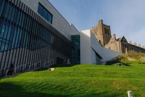 holding image. Image of grass and the side of Pontio and Main Arts in the background