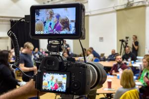 Photo of an audience through a camera lens