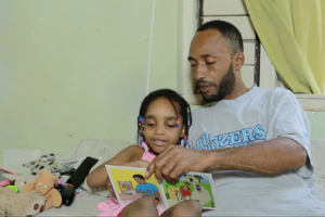 Man reads with his child.png