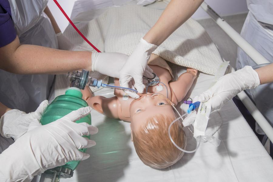 Midwifery students training on a dummy