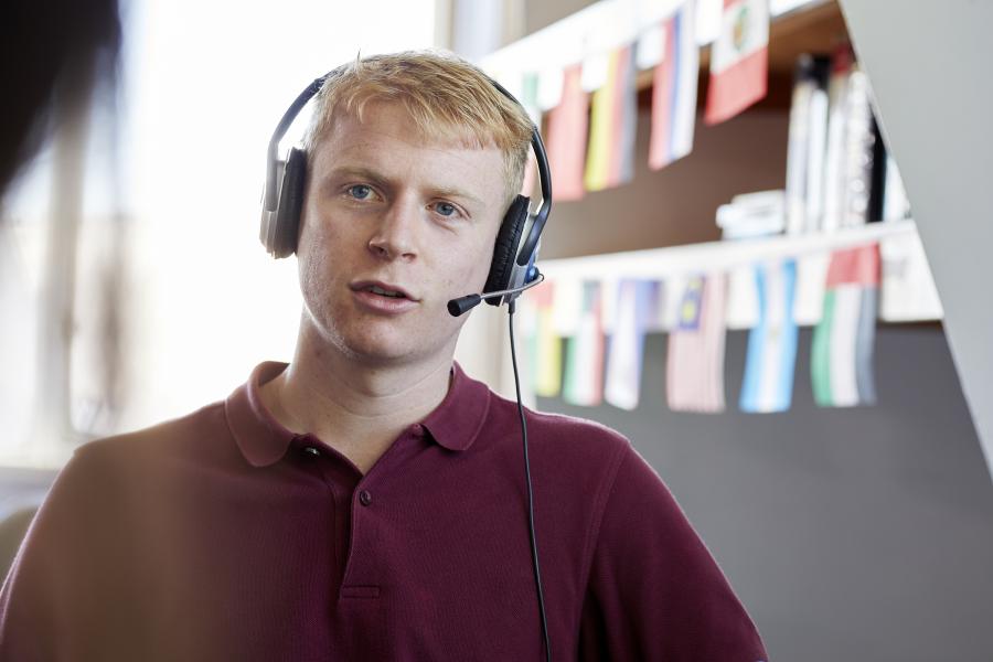 Student wearing headphones and microphone