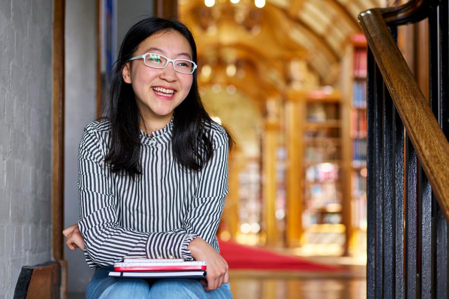 Student sitting on the stairs in the Main Arts Library