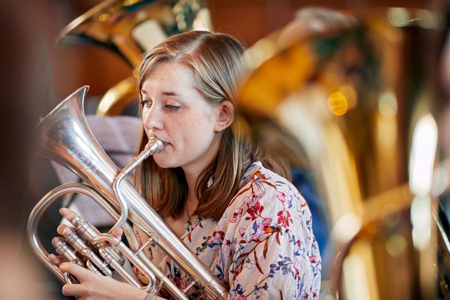 Student playing musical instrument in an orchestra