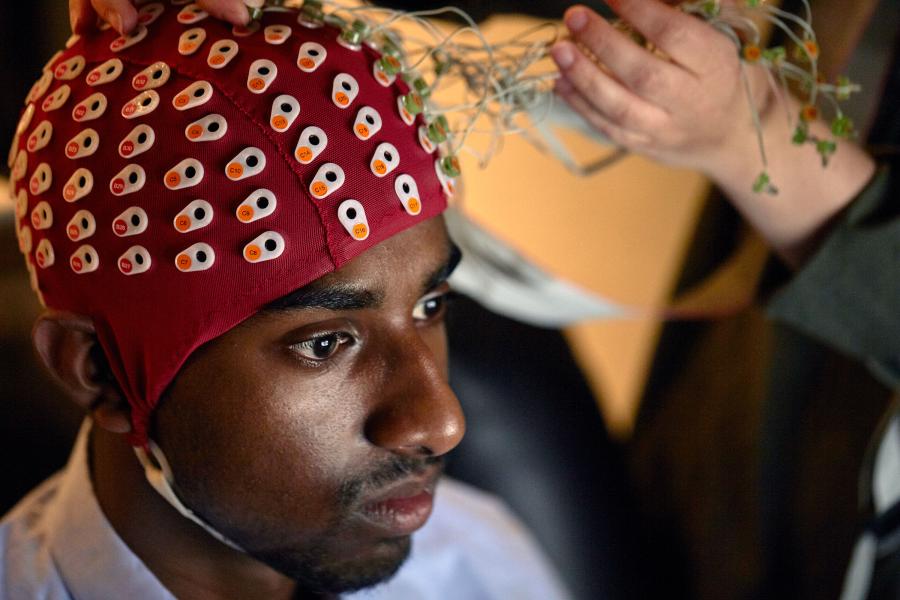 Student wearing a headpiece in a psychology study