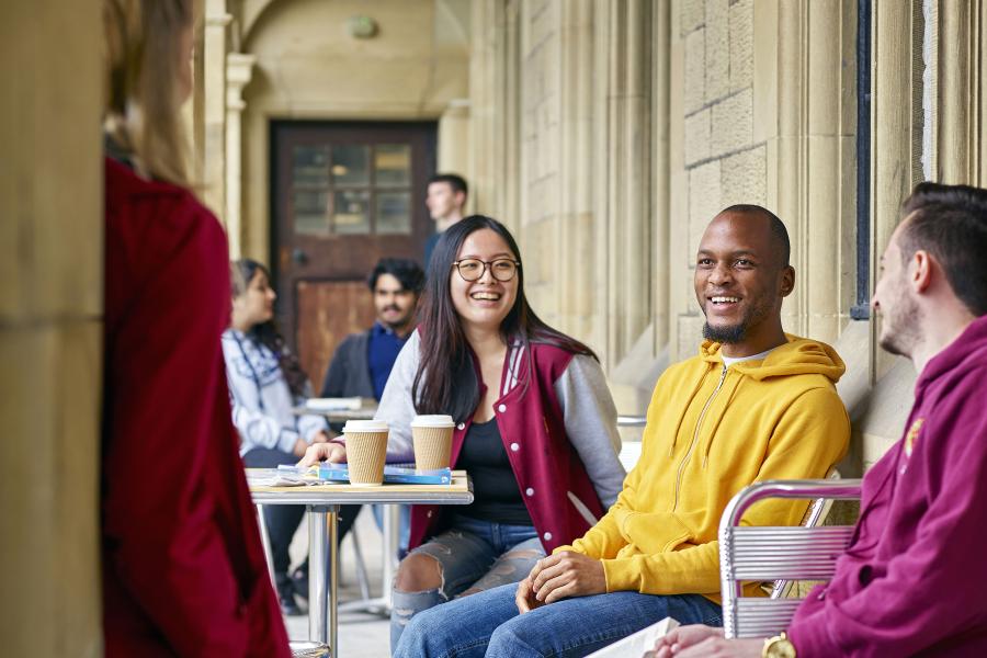 A group of students socialising outside the Main Arts Building 