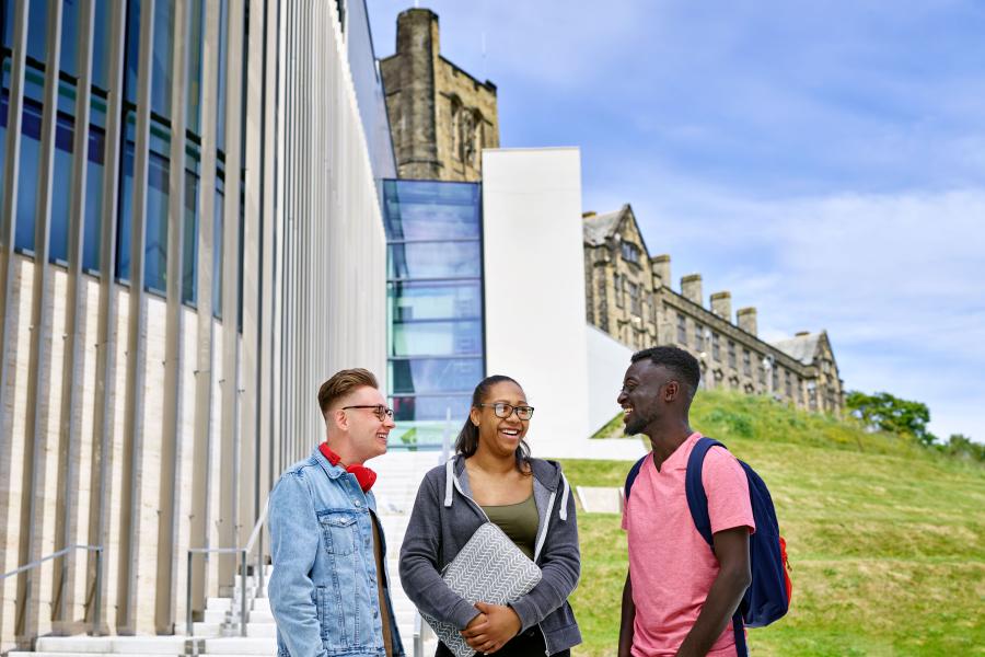 Students outside Pontio with the University's Main Arts Building in the background