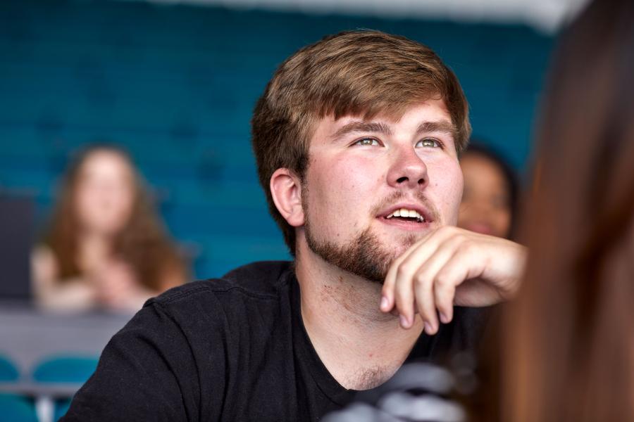 A close up of a student listening during a lecture