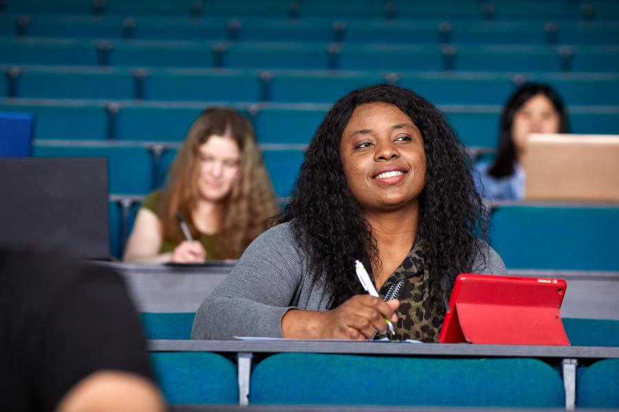 A student taking notes during a lecture