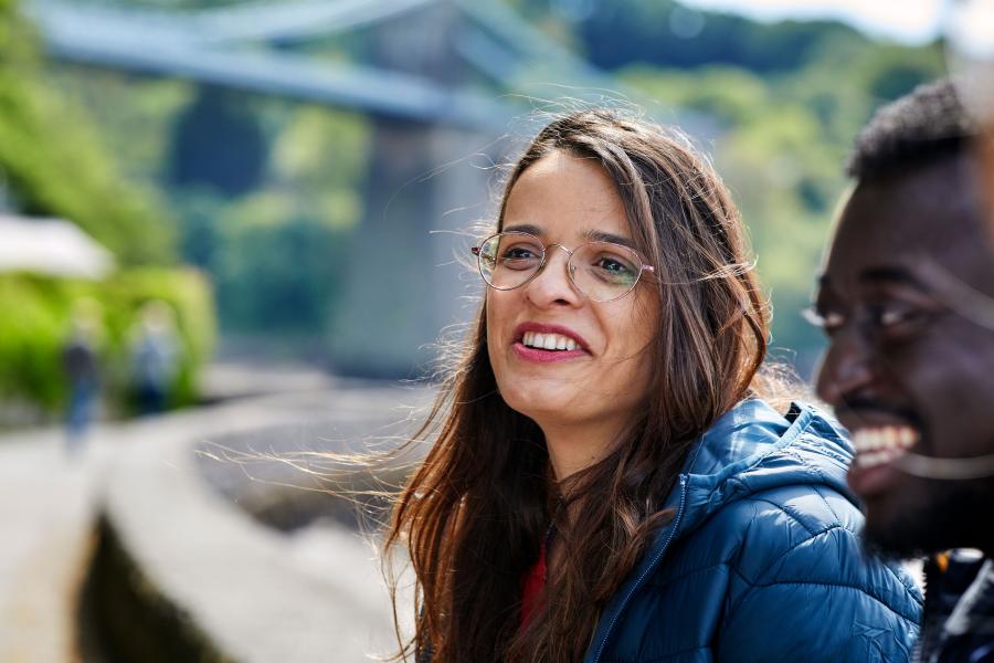 Students socialising with the Menai Suspension Bridge in the background