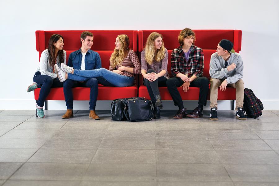 Students sitting on a sofa in Pontio