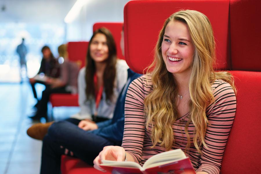 Students socialising and studying on sofas in Pontio