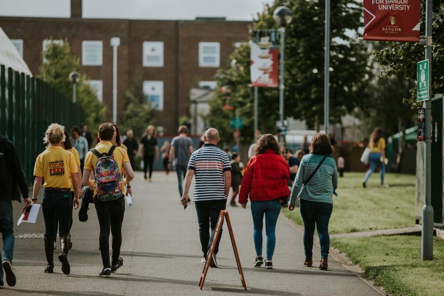 Peer Guides and new students walking through the Ffriddoedd Student Village during Welcome Week