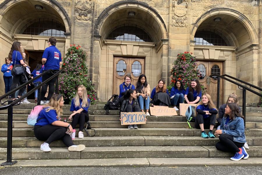 Student Peer Guides sitting outside the Main Arts Building during Welcome Week